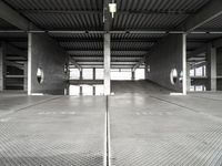 a large empty parking garage with several seats and an area for bicycles to sit on