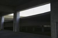 an empty parking garage with no one standing on the floor or two on the stairs