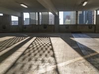 an empty parking garage is filled with parking meters and fire hydrants, some casting shadows