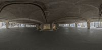 an empty parking garage with arches and arches painted white and black, with the floor painted gray