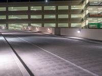 a view of a road and an overpass with traffic passing through it by buildings