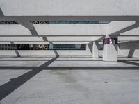 a parking garage with lots of empty spaces in front of tall buildings with glass windows