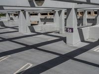 empty parking garage with concrete beams and numbers on the ceiling and floor below the number