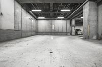 an empty parking garage that is grey and white with no signs on the floor of the garage