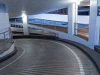 an empty and empty parking garage with stairs up to the ceiling from the bottom of the walkway