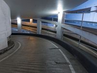 an empty and empty parking garage with stairs up to the ceiling from the bottom of the walkway