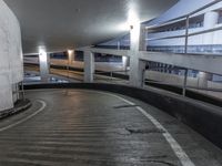 an empty and empty parking garage with stairs up to the ceiling from the bottom of the walkway