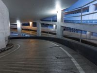 an empty and empty parking garage with stairs up to the ceiling from the bottom of the walkway