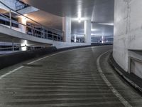 an empty and empty parking garage with stairs up to the ceiling from the bottom of the walkway