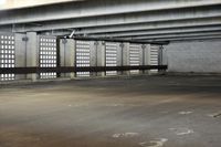 an empty parking garage filled with gray cement and windows that are open to reveal the space for skateboards