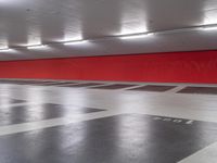 a large red box in an empty parking garage area with several boxes and a fire hydrant