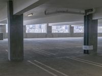 this is an empty parking garage space with a view of the city in the background