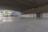 an empty parking garage with concrete floors and walls and no chairs in it and palm trees