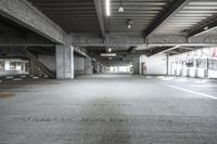 empty parking garage, one lane open to all passengers, two stairs to the left