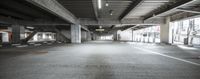 empty parking garage, one lane open to all passengers, two stairs to the left