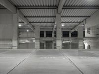 an empty parking garage with empty tires on the floor and no cars inside the building