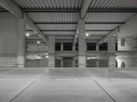 an empty parking garage with empty tires on the floor and no cars inside the building