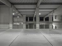 an empty parking garage with empty tires on the floor and no cars inside the building