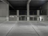 an empty parking garage with empty tires on the floor and no cars inside the building