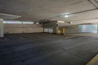 an empty parking garage with no one sitting inside of it near a fire hydrant