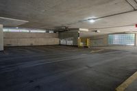 an empty parking garage with no one sitting inside of it near a fire hydrant