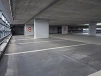 the empty parking garage of an unfinished building, has numbered numbers 3 - 8 on it