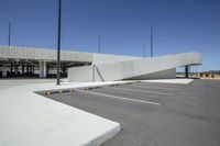 the large parking garage is empty and has lots of parking spaces to spare out the space