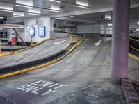 a parking garage with an empty street and several barriers surrounding it, with a sign that says not on