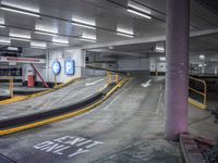 a parking garage with an empty street and several barriers surrounding it, with a sign that says not on