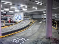 a parking garage with an empty street and several barriers surrounding it, with a sign that says not on