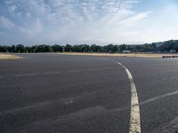 an empty parking lot with no grass or cars parked on it at the airport is ready for some change