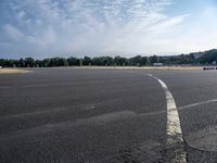 an empty parking lot with no grass or cars parked on it at the airport is ready for some change