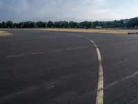 an empty parking lot with no grass or cars parked on it at the airport is ready for some change