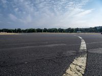 an empty parking lot with no grass or cars parked on it at the airport is ready for some change