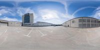 this is a 360 - view image of an empty parking lot outside a large building