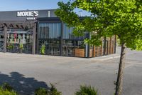 the empty parking lot near a bike store in urban area with sun shining through windows