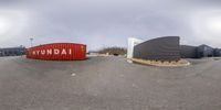 a fish eye view of an empty parking lot and a building with the words ionn on it