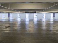 a empty parking lot with signs on the ceiling and windows, with a lot in the middle