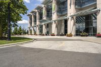 an empty parking lot with a canopy over the street, surrounded by many different planters and flowers