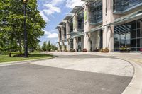 an empty parking lot with a canopy over the street, surrounded by many different planters and flowers