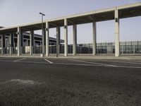 an empty parking lot with several cars parked in it and no one walking into the terminal