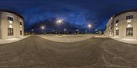 the picture shows a very empty parking lot on a cloudy night with no one at all