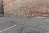 an empty parking lot with an empty building on one side and a fire hydrant to the right