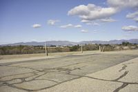 a view of a empty parking lot in the desert with a long pole on one corner