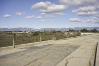 a view of a empty parking lot in the desert with a long pole on one corner