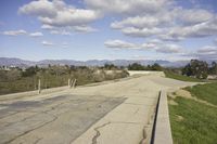 a view of a empty parking lot in the desert with a long pole on one corner