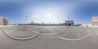 the view of a empty parking lot in the city of a city street with multiple circles