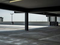 empty parking lot with open doors, no one on it, and light posts above the area