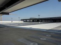 empty parking lot with open doors, no one on it, and light posts above the area