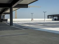 empty parking lot with open doors, no one on it, and light posts above the area